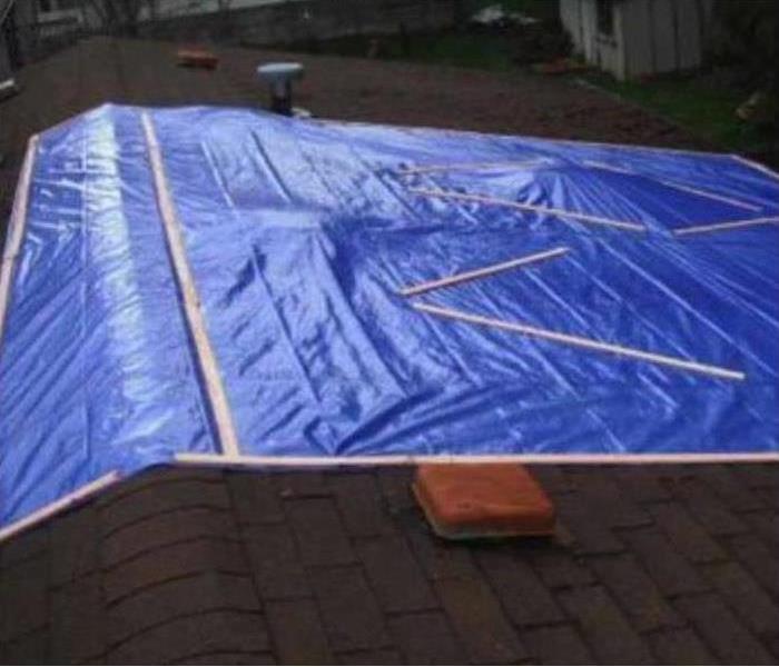 roof top tarped with blue tarp